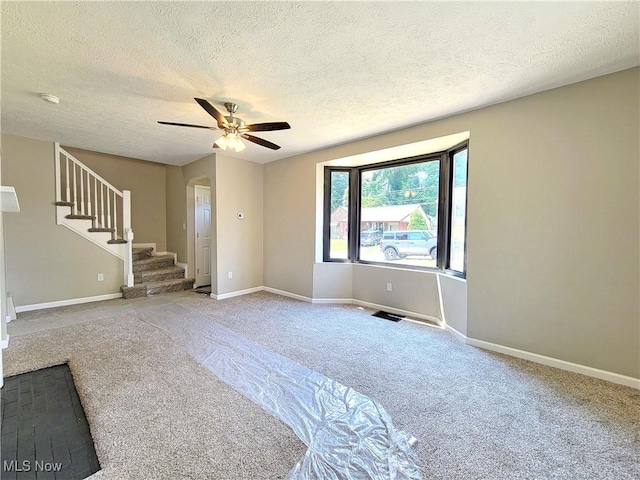 1006 Jackson Ave, Parkersburg, WV 26101 - empty room with carpet floors, arched walkways, a textured ceiling, stairway, and a ceiling fan