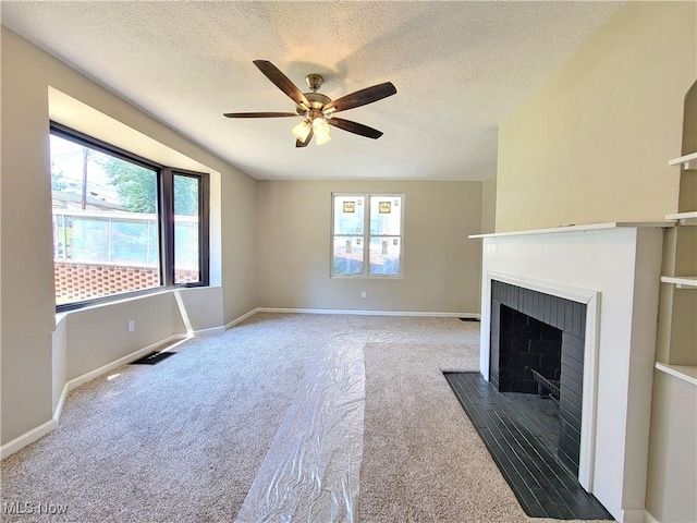 1006 Jackson Ave, Parkersburg, WV 26101 - unfurnished living room featuring carpet, a fireplace, ceiling fan, and a textured ceiling