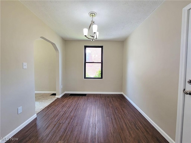 1006 Jackson Ave, Parkersburg, WV 26101 - spare room featuring arched walkways, dark wood-style flooring, and a textured ceiling