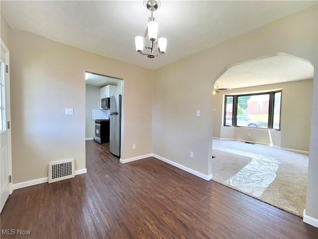 1006 Jackson Ave, Parkersburg, WV 26101 - spare room with arched walkways, dark wood-type flooring, and a chandelier