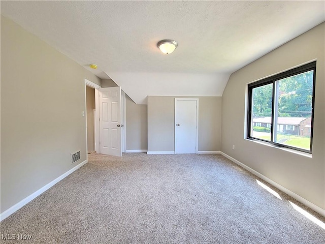 1006 Jackson Ave, Parkersburg, WV 26101 - unfurnished bedroom featuring vaulted ceiling, carpet floors, and a textured ceiling