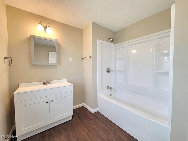 1006 Jackson Ave, Parkersburg, WV 26101 - full bathroom featuring wood finished floors, vanity, shower / bath combination, and a textured ceiling
