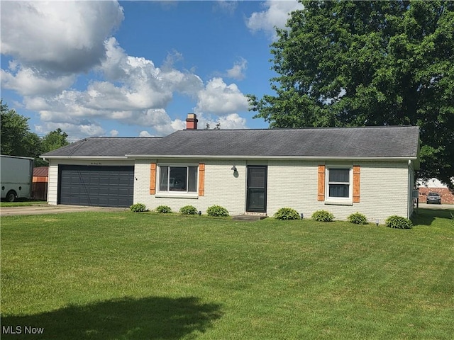 221 S Elm St, Jefferson, OH 44047 - single story home featuring a garage, a front lawn, concrete driveway, a chimney, and brick siding
