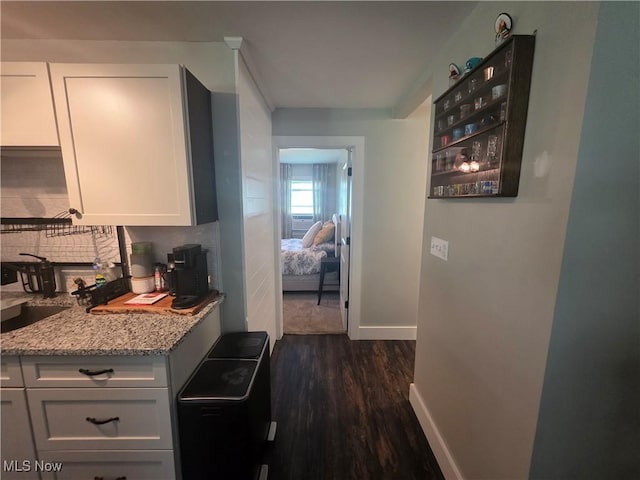 221 S Elm St, Jefferson, OH 44047 - kitchen with dark wood finished floors, white cabinets, and light stone countertops