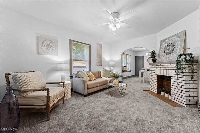 2602 Fletcher Ave NE, Canton, OH 44705 - living room featuring arched walkways, a ceiling fan, carpet, and a fireplace