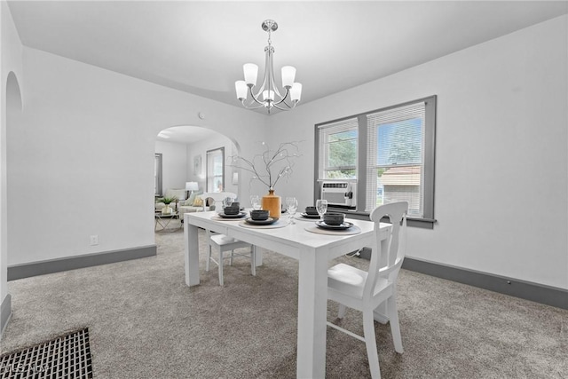 2602 Fletcher Ave NE, Canton, OH 44705 - carpeted dining space with arched walkways, a chandelier, and cooling unit