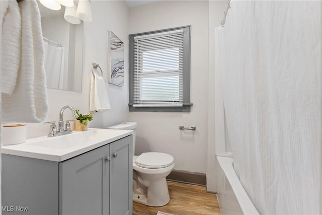 2602 Fletcher Ave NE, Canton, OH 44705 - full bath featuring vanity, wood finished floors, and shower / bath combo with shower curtain