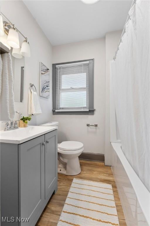 2602 Fletcher Ave NE, Canton, OH 44705 - bathroom with vanity, wood finished floors, and shower / bath combination with curtain