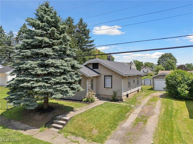 2602 Fletcher Ave NE, Canton, OH 44705 - bungalow-style house featuring driveway, an outbuilding, a front yard, and roof with shingles