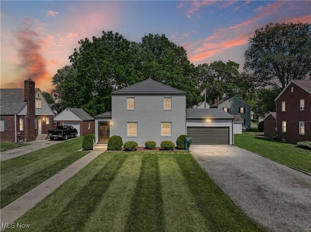1146 Raff Rd SW, Canton, OH 44710 - traditional-style home with a lawn, an outbuilding, gravel driveway, and a garage