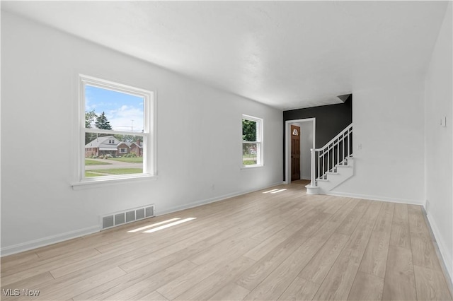 1146 Raff Rd SW, Canton, OH 44710 - unfurnished living room with light wood-type flooring and stairway