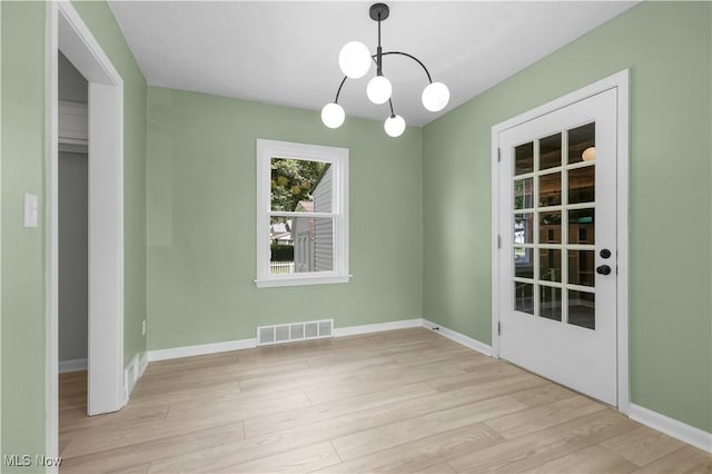 1146 Raff Rd SW, Canton, OH 44710 - unfurnished dining area featuring a chandelier and wood finished floors