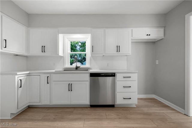 1146 Raff Rd SW, Canton, OH 44710 - kitchen featuring dishwasher, light countertops, white cabinets, and light wood-style flooring