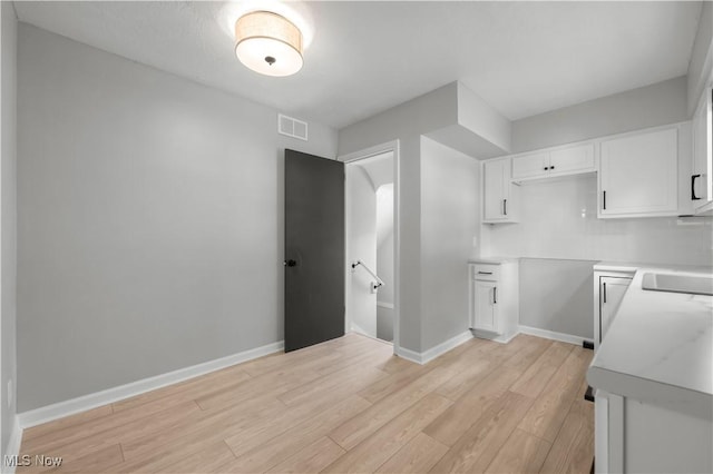 1146 Raff Rd SW, Canton, OH 44710 - kitchen featuring white cabinetry, light wood-type flooring, and light countertops