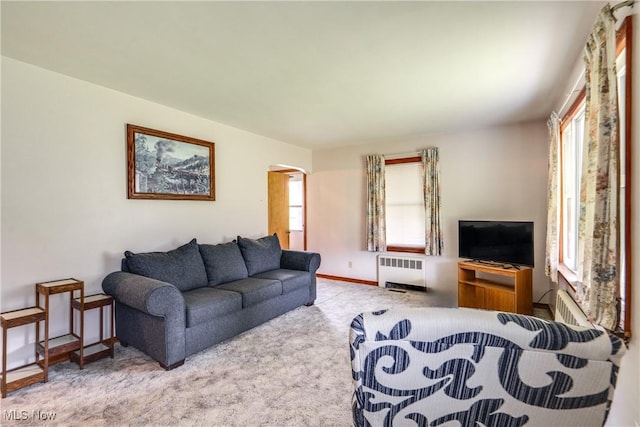 3985 Etter Rd, Mogadore, OH 44260 - living area featuring radiator heating unit, carpet, and arched walkways