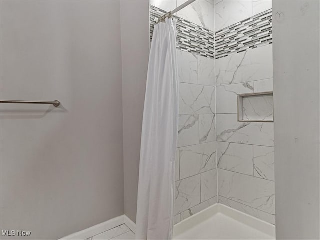 5265 Bellview St, Maple Heights, OH 44137 - bathroom featuring tiled shower and marble finish flooring