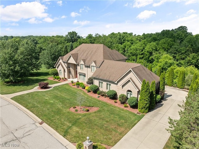 112 Caraplace, Wintersville, OH 43953 - view of front of home with a front yard and a view of trees