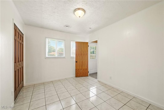 5149 Langfitt St, Vermilion, OH 44089 - empty room featuring a textured ceiling and light tile patterned floors