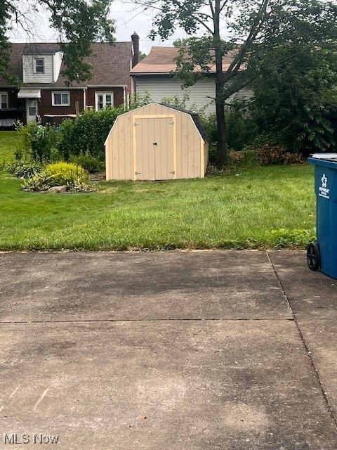 86 Fatima, Campbell, OH 44405 - view of grassy yard featuring a storage shed