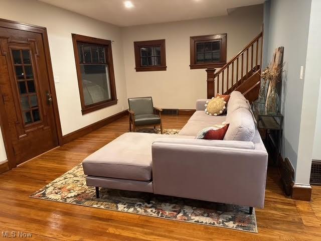 21430 Lakeshore Blvd, Euclid, OH 44123 - living room with stairs, wood finished floors, and recessed lighting