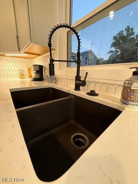 21430 Lakeshore Blvd, Euclid, OH 44123 - kitchen view of tasteful backsplash and light stone counters