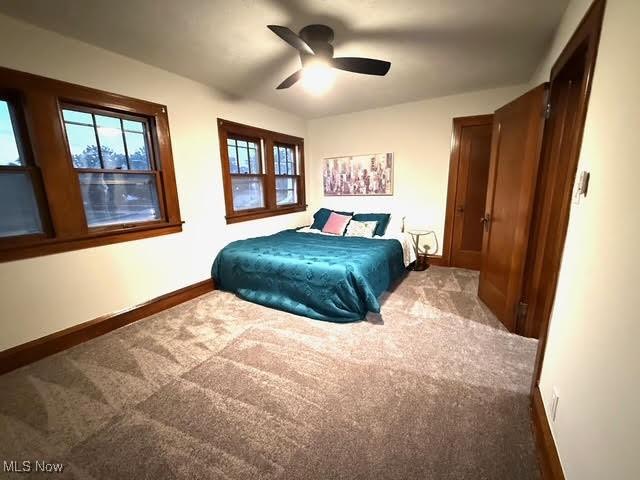 21430 Lakeshore Blvd, Euclid, OH 44123 - carpeted bedroom with baseboards and a ceiling fan