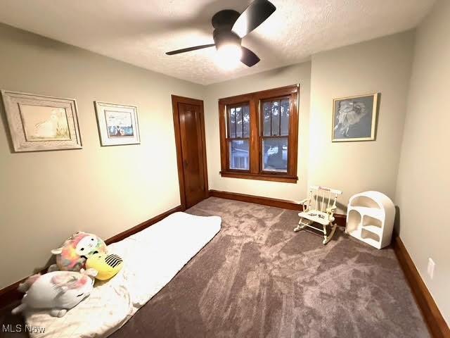 21430 Lakeshore Blvd, Euclid, OH 44123 - carpeted bedroom with baseboards and a ceiling fan
