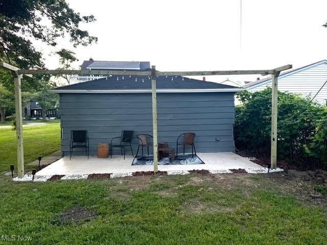 21430 Lakeshore Blvd, Euclid, OH 44123 - back of property with a patio area and a lawn