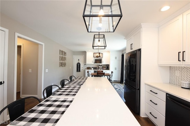 1524 Walker Rd, Follansbee, WV 26037 - kitchen with black appliances, decorative backsplash, light countertops, white cabinets, and decorative light fixtures