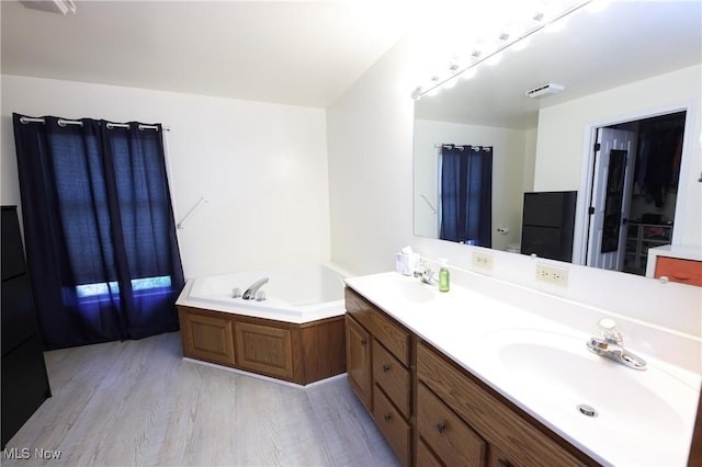1524 Walker Rd, Follansbee, WV 26037 - bathroom featuring double vanity, a bath, and wood finished floors