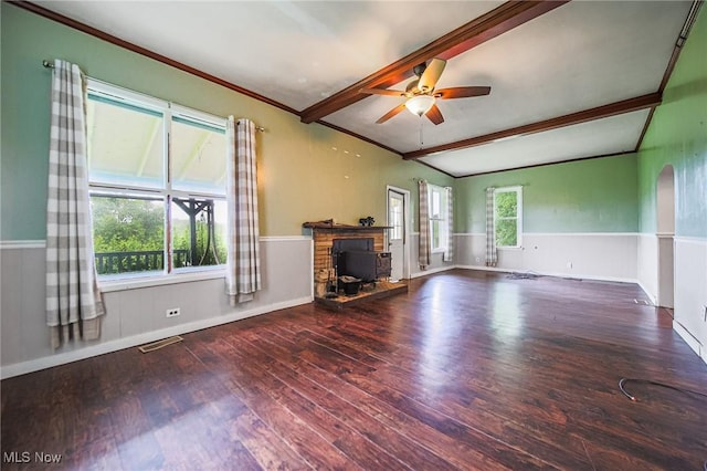 2461 Peters Creek Rd, Cambridge, OH 43725 - unfurnished living room featuring ornamental molding, wood finished floors, ceiling fan, a wainscoted wall, and arched walkways