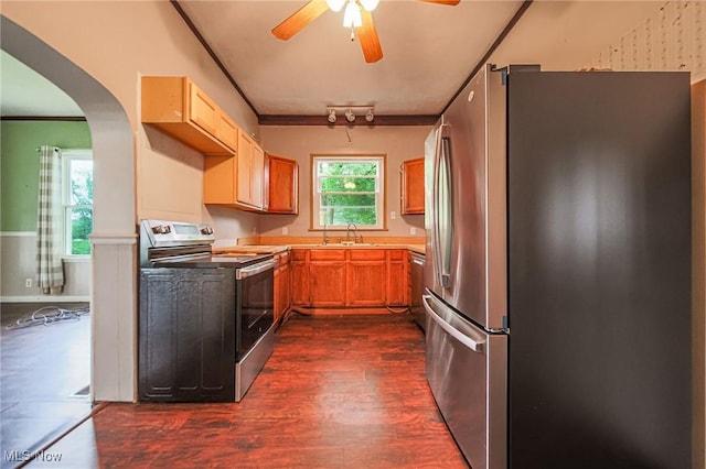 2461 Peters Creek Rd, Cambridge, OH 43725 - kitchen featuring stainless steel appliances, arched walkways, dark wood finished floors, a ceiling fan, and ornamental molding