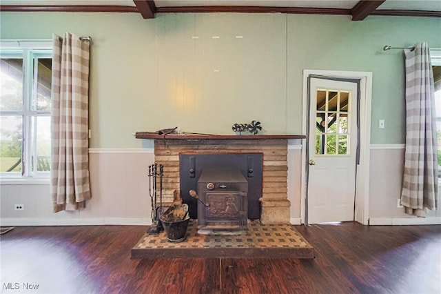 2461 Peters Creek Rd, Cambridge, OH 43725 - unfurnished living room featuring wood finished floors, beamed ceiling, healthy amount of natural light, a wood stove, and ornamental molding