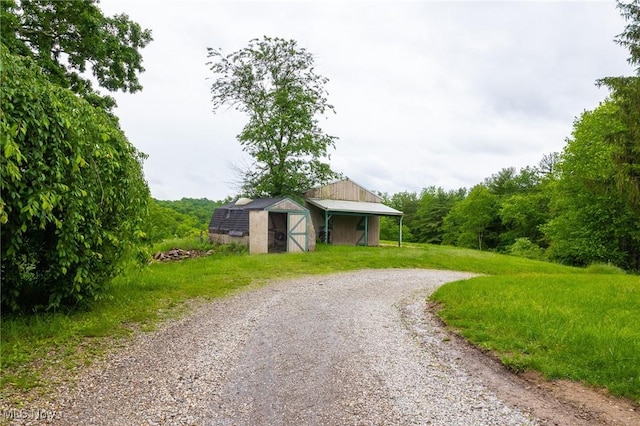 2461 Peters Creek Rd, Cambridge, OH 43725 - view of dirt / gravel road featuring a pole building