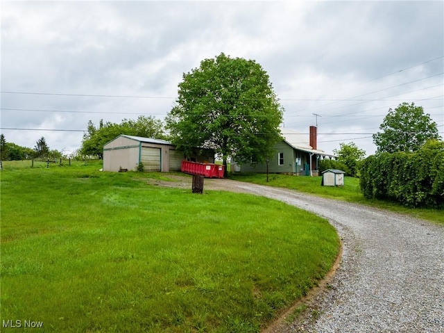 2461 Peters Creek Rd, Cambridge, OH 43725 - single story home with an outbuilding, driveway, a garage, and a front lawn