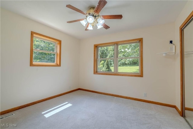 114 Buckner Bend Rd, Walker, WV 26180 - unfurnished bedroom with light carpet, a closet, and ceiling fan