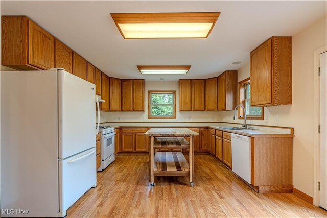 114 Buckner Bend Rd, Walker, WV 26180 - kitchen with white appliances, light countertops, brown cabinets, and healthy amount of natural light
