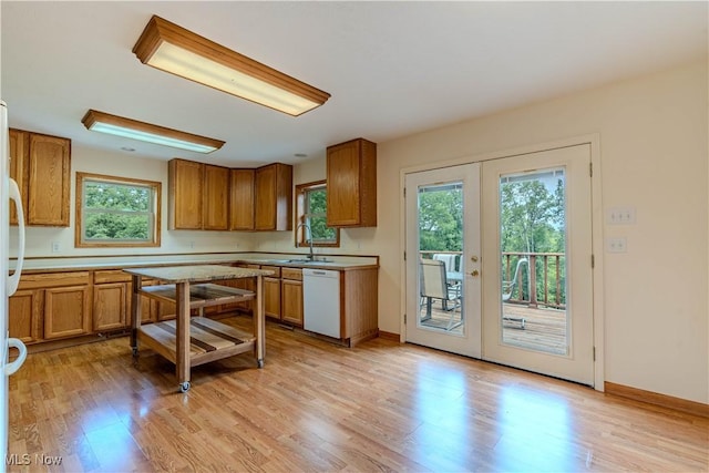 114 Buckner Bend Rd, Walker, WV 26180 - kitchen with white dishwasher, french doors, brown cabinetry, and healthy amount of natural light