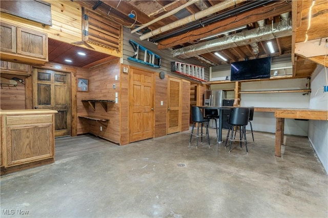 114 Buckner Bend Rd, Walker, WV 26180 - below grade area with wooden walls and stainless steel refrigerator with ice dispenser