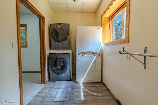 114 Buckner Bend Rd, Walker, WV 26180 - laundry area with estacked washer and dryer and wood finished floors