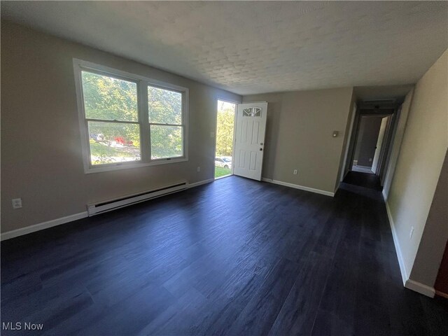 9420 Cedar Ct W, Nashport, OH 43830 - unfurnished living room featuring a baseboard radiator, dark wood-type flooring, and a textured ceiling