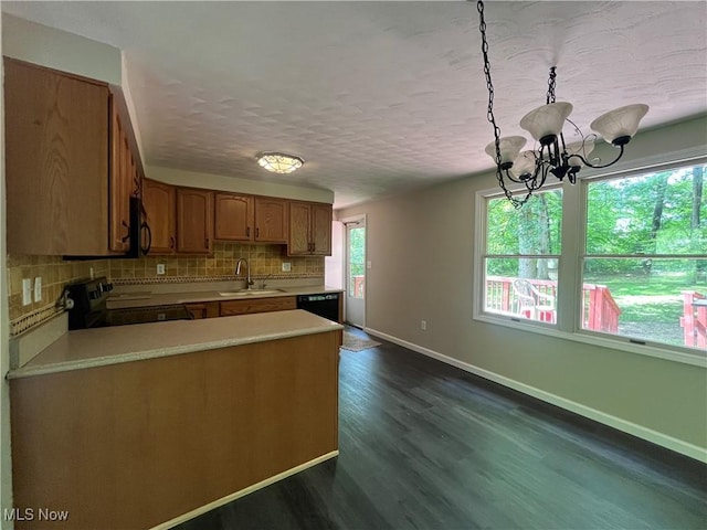 9420 Cedar Ct W, Nashport, OH 43830 - kitchen with black appliances, light countertops, tasteful backsplash, brown cabinets, and dark wood-style flooring