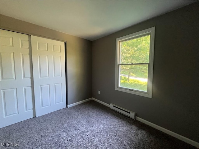 9420 Cedar Ct W, Nashport, OH 43830 - unfurnished bedroom with a baseboard radiator and dark carpet