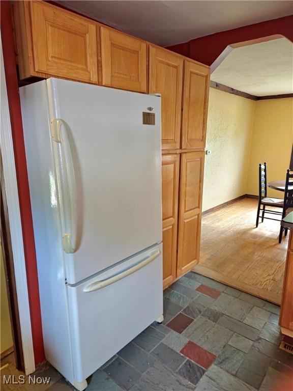 17405 Schenely Ave, Cleveland, OH 44119 - kitchen featuring freestanding refrigerator and dark stone finish flooring