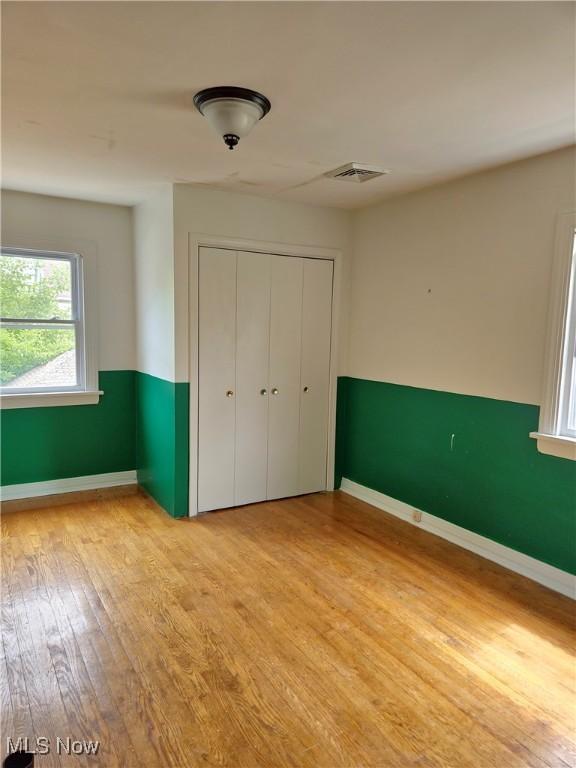 17405 Schenely Ave, Cleveland, OH 44119 - unfurnished bedroom featuring wood finished floors and a closet