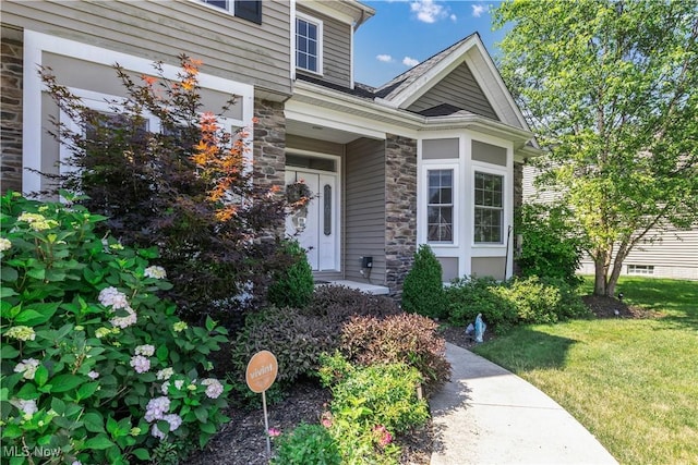 12110 Cora Ct, Concord, OH 44077 - doorway to property with stone siding and a lawn