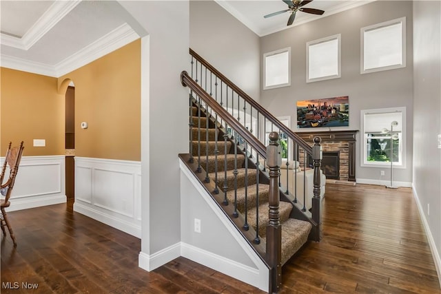 12110 Cora Ct, Concord, OH 44077 - stairs with arched walkways, a ceiling fan, hardwood / wood-style floors, crown molding, and a fireplace