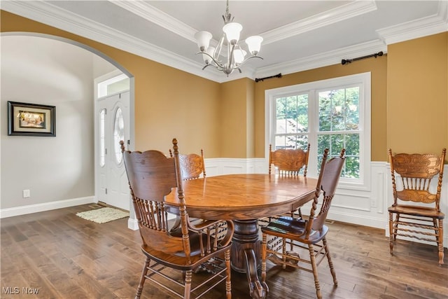 12110 Cora Ct, Concord, OH 44077 - dining space with arched walkways, dark wood-style floors, a chandelier, wainscoting, and crown molding