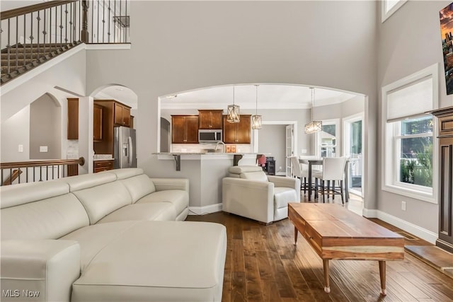 12110 Cora Ct, Concord, OH 44077 - living room with a high ceiling, dark wood finished floors, and arched walkways