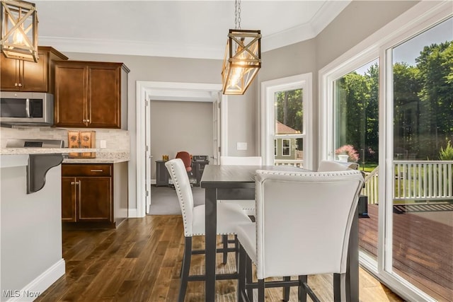 12110 Cora Ct, Concord, OH 44077 - dining area featuring dark wood-style flooring and ornamental molding